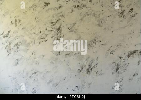 Textured plaster wall with mottled finish close up. Stock Photo