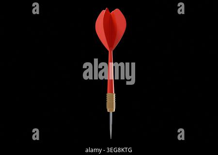 ingle red dart with a brass barrel and sharp metal tip, pointing down. Minimalist composition isolated on a solid black background, symbolizing focus, Stock Photo