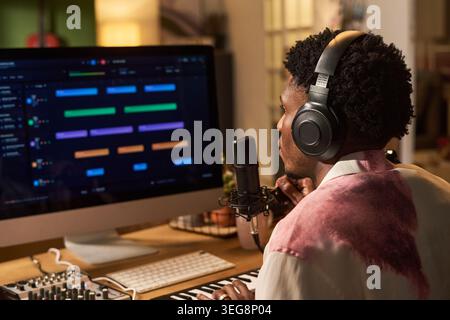 Black Young Man Recording Music at Home Studio for Content Creation Stock Photo