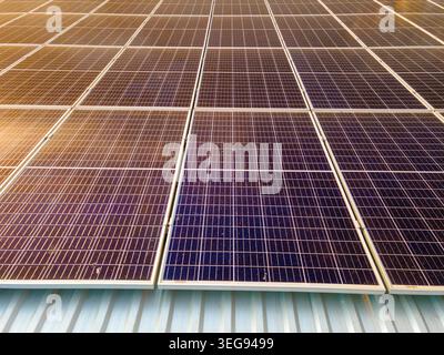 Photovoltaic panels on solar rooftops of commercial building for producing clean ecological electrical energy. Renewable electricity with zero Stock Photo