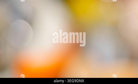 Warm abstract bokeh background with orange yellow and gray blurred circular light spots Stock Photo