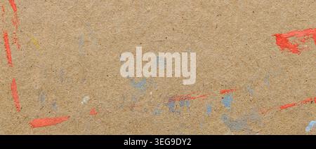 Brown kraft paper texture with colorful red and blue paint splashes for creative background Stock Photo