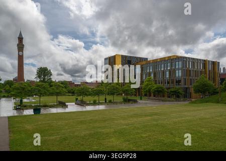University of Birmingham campus showing the new library and Old Joe, clock tower, on a spring day with big white clouds and sun shining Stock Photo