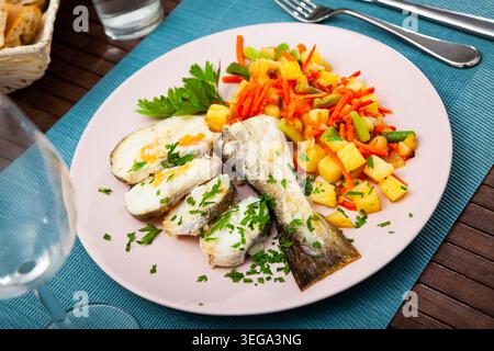Oven baked hake with vegetable garnish Stock Photo
