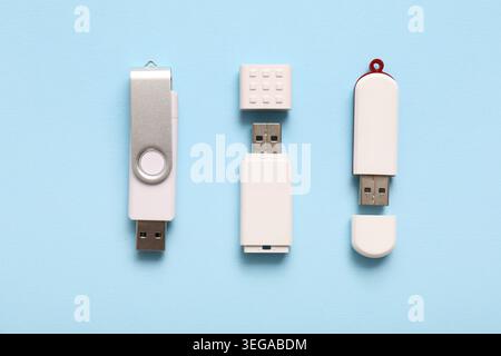 Different USB flash drives on blue background Stock Photo
