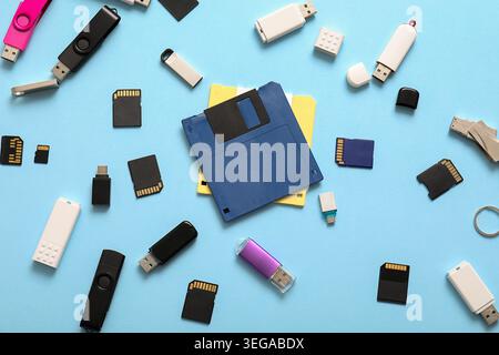 Composition with floppy disks, USB flash drives and SD cards on blue background Stock Photo