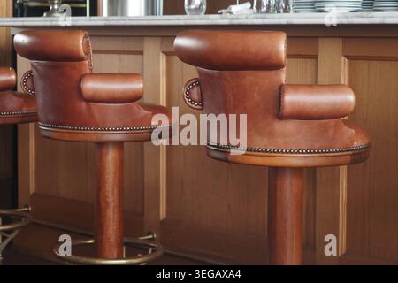 Brown bar stools in a modern kitchen setting Stock Photo
