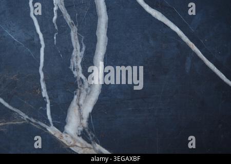 Marble surface with white veins on dark background Stock Photo