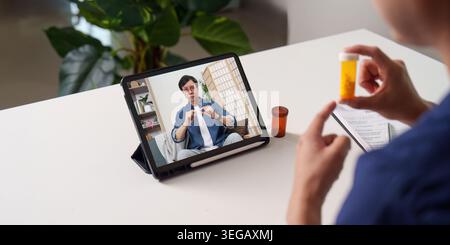 Asian man on tablet having telemedicine consultation about medication Stock Photo