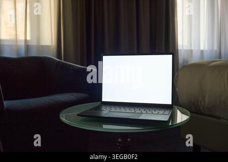 Laptop Displaying Blank Screen for Product Mockup in Home Office Stock Photo