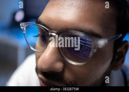 Indian Software Developer Wearing Glasses With Code Reflection On Lens Stock Photo