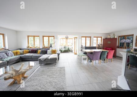 Spacious living area with sofa, dining area and lots of windows, modern and bright design, holiday apartment, Gundhabing, Austria Stock Photo