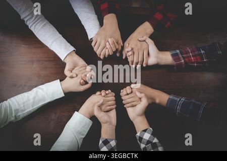 Top view close up shot of professional successful group of businessman businesswoman colleagues partnership team hands holding together, Teamwork Join Stock Photo