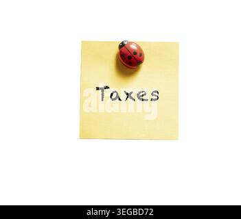 A colored memo sheet with writing taxes on a transparent background Stock Photo