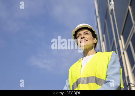 Portrait of a happy construction worker in a safety vest. Copy space Stock Photo