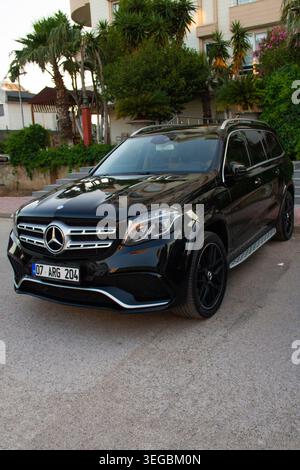 Black Mercedes-Benz GLS luxury SUV with AMG styling parked outside a residential building, Antalya, Turkey, May 2026. Stock Photo