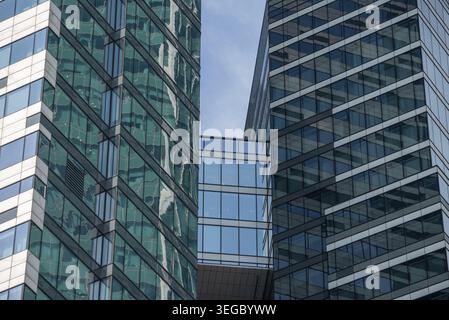 Walls and windows of high business building bottom view architectural background pattern abstract Stock Photo