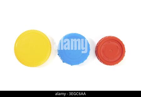 Yellow blue and red plastic screw caps isolated on white background Stock Photo