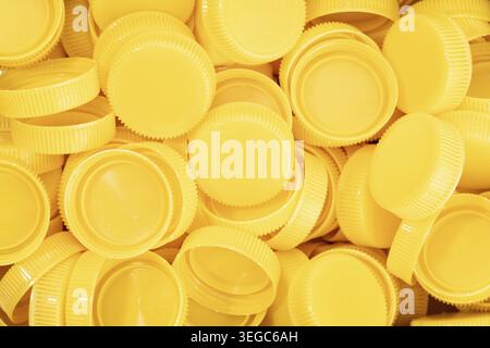 Yellow plastic screw caps background Stock Photo