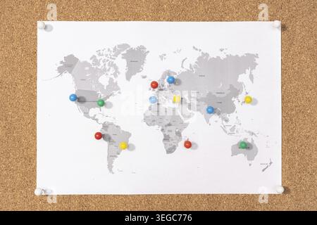 Planning Travel destination concept. Pushpins on world map on Corkboard Stock Photo