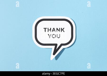 Thank you text on speech bubble isolated on blue background Stock Photo