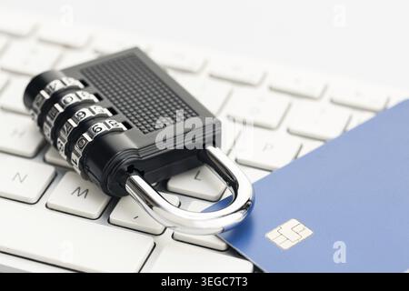 Padlock and credit card on computer keyboard. E-commerce internet and finance security concept Stock Photo
