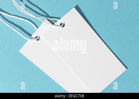 Blank white price tags isolated on blue background. template mock up Stock Photo