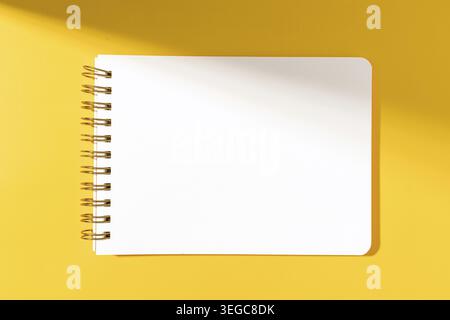 Blank paper notebook Isolated on yellow background. Template mock up Stock Photo