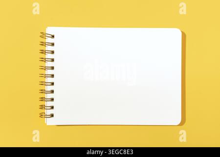 Blank paper notebook Isolated on yellow background. Template mock up Stock Photo
