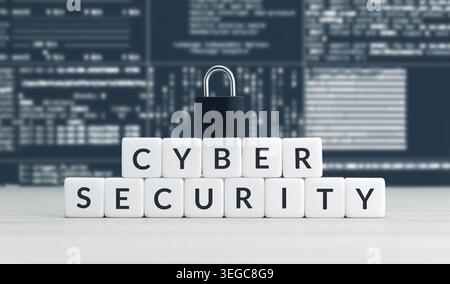 Cyber security words on cube blocks, closed padlock and computer data screen at background Stock Photo