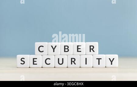 Cyber security concept. Text on cube blocks on blue background. Copy space Stock Photo