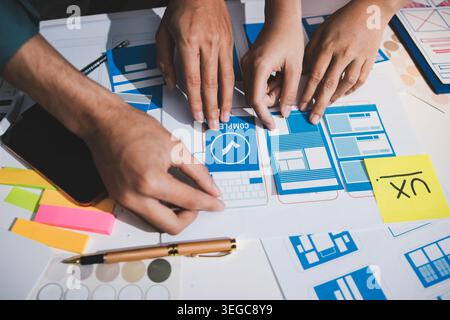 UI designer and UX developer brainstorm idea to design the application appearance in the early stage. Creative digital development agency. UX UI conce Stock Photo