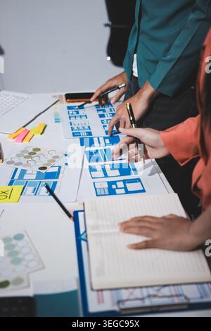 UI designer and UX developer brainstorm idea to design the application appearance in the early stage. Creative digital development agency. UX UI conce Stock Photo
