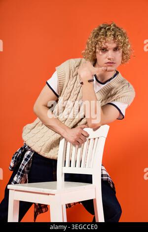 Curly haired young student showcases unique fashion in a lively studio atmosphere Stock Photo