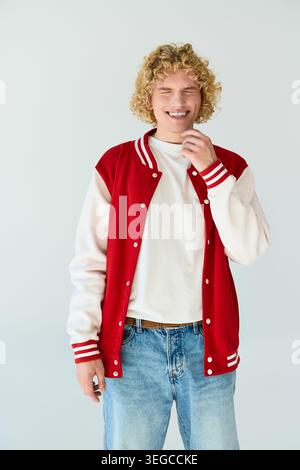 Blonde curly haired student showcases his fashionable look in a studio setting Stock Photo
