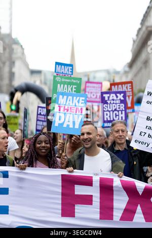 Green Party Leader Zack Polanski is seen behind a banner as protesters gather and march during a demonstration called by Make Them Pay, a civil society alliance, in central London, with 3 key demands: tax the super-rich; protect workers, not billionaires; make polluters pay. Stock Photo