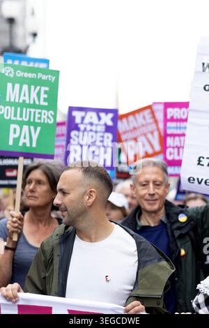 Green Party Leader Zack Polanski is seen behind a banner as protesters gather and march during a demonstration called by Make Them Pay, a civil society alliance, in central London, with 3 key demands: tax the super-rich; protect workers, not billionaires; make polluters pay. Stock Photo