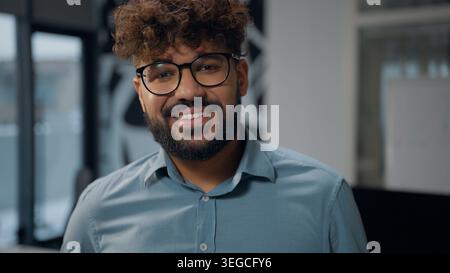 Portrait Arabian business man smiling toothy putting on glasses eyesight health vision medicine cheerful ethnic business man put on stylish eyeglasses Stock Photo