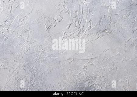 White textured plaster wall background with abstract decorative pattern and soft neutral surface for design and branding. Stock Photo