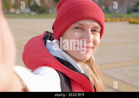 Vibrant female tourist woman holding map exploring new city and using phone , looking around searching for right destination Stock Photo