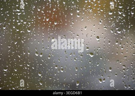 The water droplets on the glass create a mesmerizing effect, perfect for backgrounds and textures Stock Photo