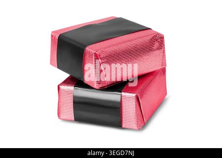 Two candies wrapped in pink foil paper isolated on white background Stock Photo