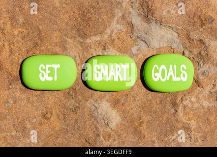 Set smart goals words symbol. Concept words Set smart goals on beautiful green stones. Beautiful stone beach background. Business and set smart goals Stock Photo