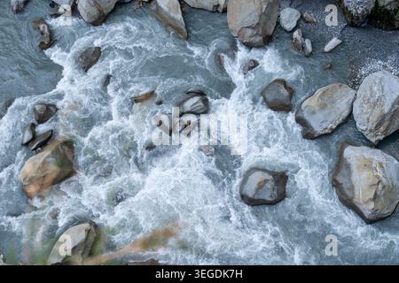 Powerful river rapids flowing over large natural rocks Stock Photo