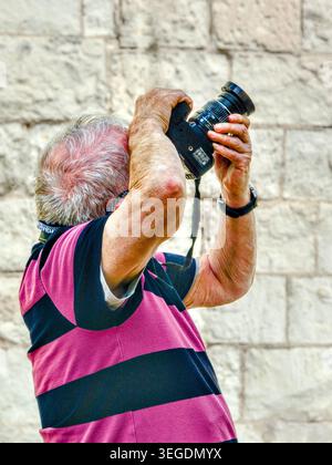 Amateur photographer pointing Nikon DSLR upwards - Beaulieu-les-Loches, Indre-et-Loire (37), France. Stock Photo