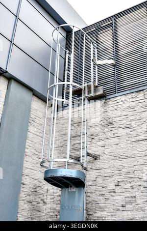 "Coutier Industrie" anti-intrusion control door panel on fixed roof ladder of supermarket building - Loches, Indre-et-Loire (37), France. Stock Photo