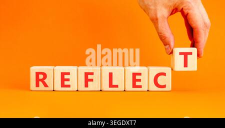 Reflect word symbol. Concept word Reflect on beautiful wooden blocks. Beautiful orange background. Psychologist's hand. Business psychological reflect Stock Photo