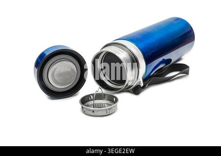 A metallic blue vacuum insulated thermos flask lying open on a white background, showing its stainless steel interior, screw cap lid, and a removable Stock Photo