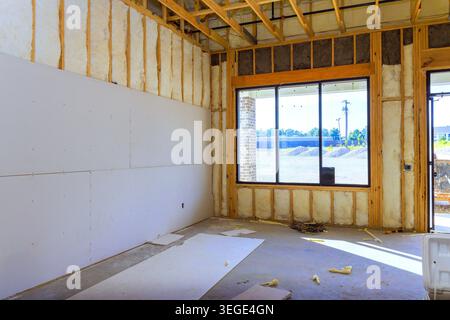 Workers are preparing space for future construction with drywall open framing inside. Stock Photo