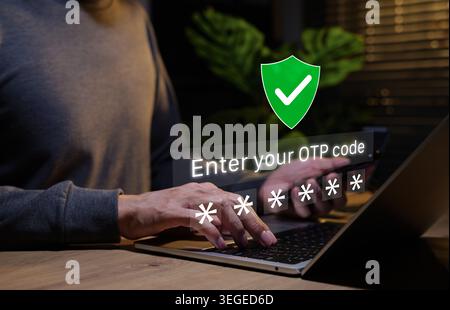 Two-factor authentication and online security concept. Person typing on laptop and OTP code input with password symbols and shield checkmark Stock Photo